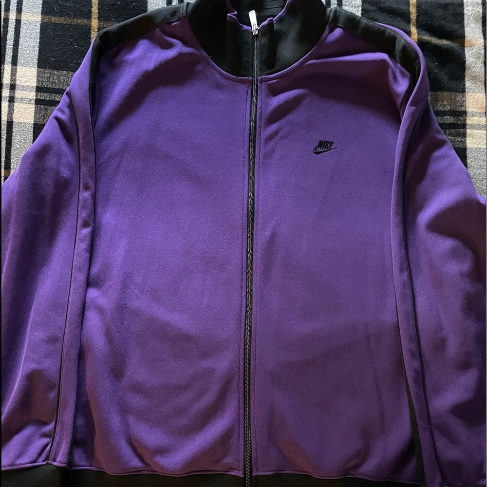 A purple and Black Nike track jacket